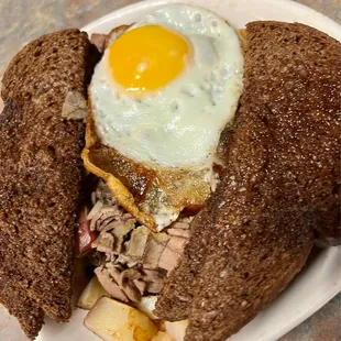 a half eaten sandwich with an egg