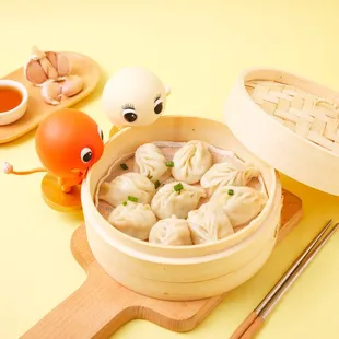 a bowl of dumplings and chopsticks