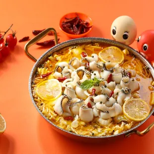 a dish of squid and lemons