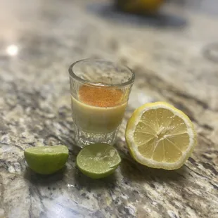 Ginger shot with turmeric oil of oregano key lime &amp; lemon