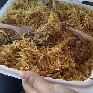a person holding a tray of food