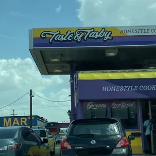 cars parked in front of a restaurant