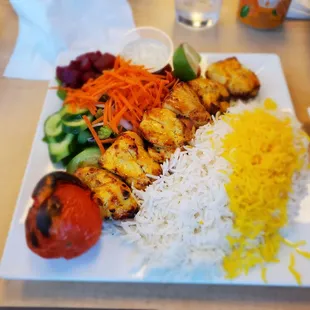 Boneless chicken kabob with salad.