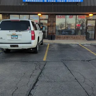 a white truck parked in front of a restaurant