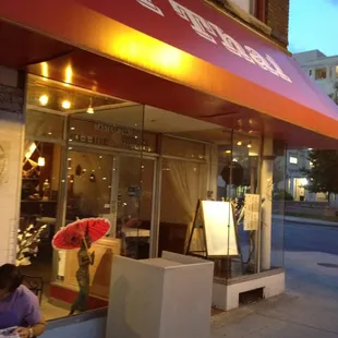 a woman sitting outside a restaurant