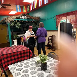 two women standing at a table