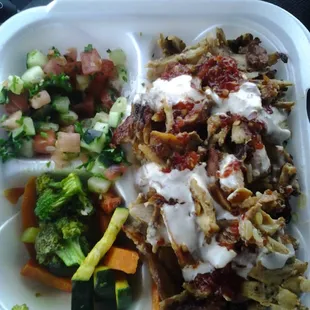 Chicken Shawarma combo plate. The chicken shawarma on right, salad on top left, cooked veggies bottom left.