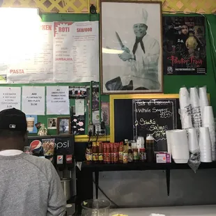 a man standing at a counter in a restaurant