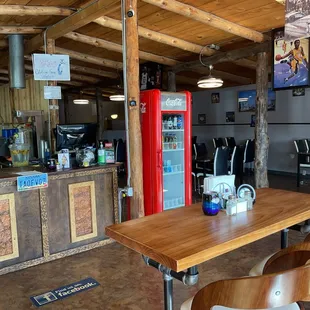 a bar with a wooden table and chairs