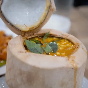 a bowl of soup in a coconut shell