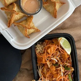 a plate of fried vegetable spring rolls and a bowl of dipping sauce