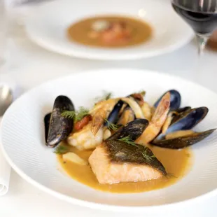 a plate of seafood and a glass of wine