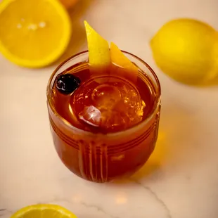 a drink with a lemon garnish