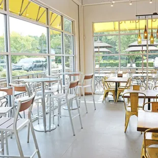 tables and chairs in a restaurant with large windows