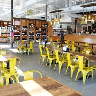 a restaurant with tables and yellow chairs