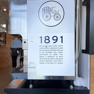 a coffee machine with a sign on it