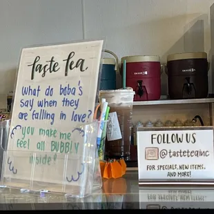 a sign on a counter in a cafe