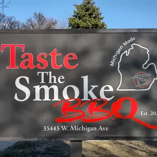 a sign for taste the smoke bbq