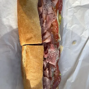 a sub sandwich with meat and cheese