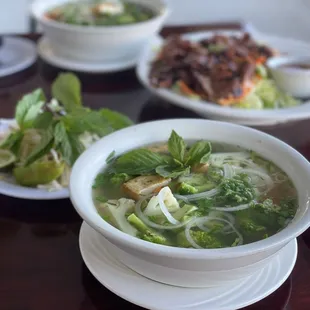 a bowl of soup and a plate of salad