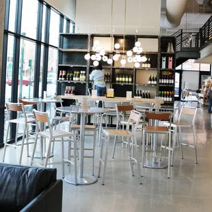 a restaurant with tables and chairs in front of large windows