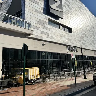 the outside of a restaurant with tables and chairs