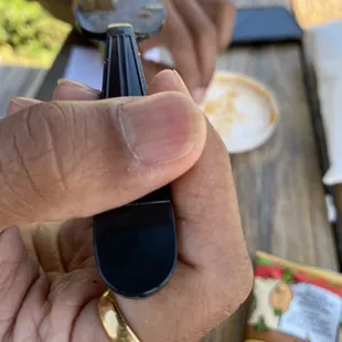 a person's hand holding a bottle of coffee