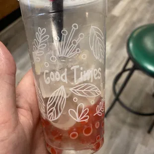 a hand holding a cup of iced tea