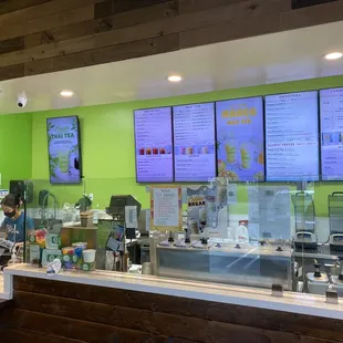 Lots of different choices for drinks on the menu, front counter area clean.