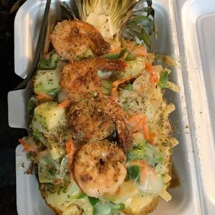 Shrimp fettuccine in a pineapple bowl.