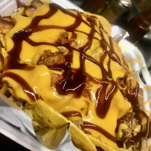 a hot dog covered in cheese and sauce