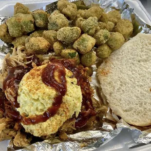 a tray of food with a sandwich and tater tots