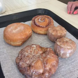 a variety of doughnuts on a tray