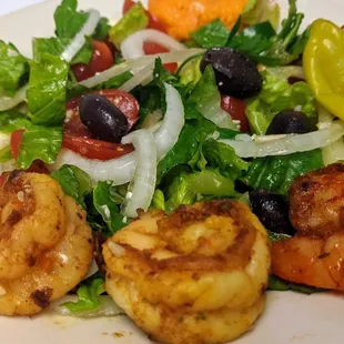 a plate of shrimp and salad