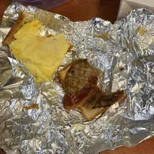 a sausage and cheese sandwich wrapped in aluminum foil
