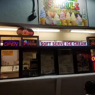a man standing in front of the ice cream shop