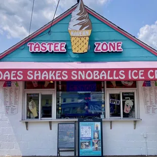 Front of store with flavors listed on boards.