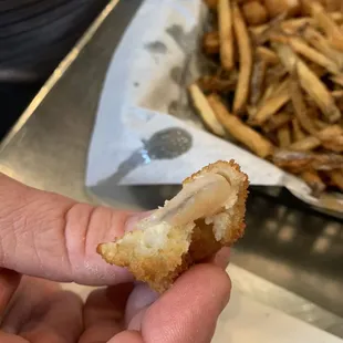 a person holding a half eaten piece of food