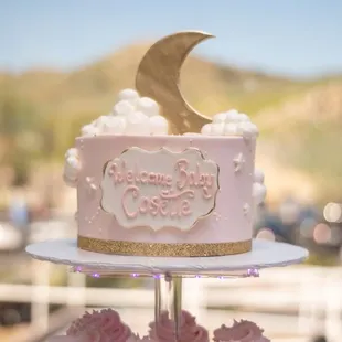 a pink cake with a crescent on top