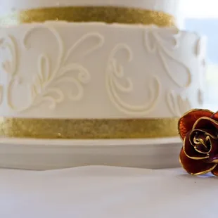 a white and gold wedding cake
