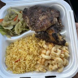 Jerk chicken dinner with rice, cabbage, and baked mac.