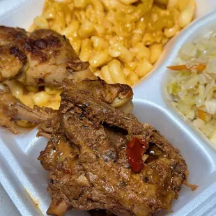 a tray of meat and macaroni and cheese
