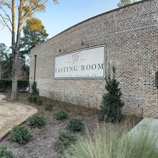 a brick building with a sign that says tasting room