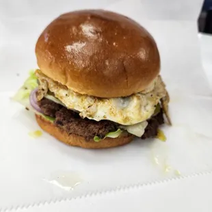 a hamburger with egg and lettuce