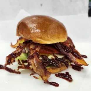 a burger with bacon and lettuce