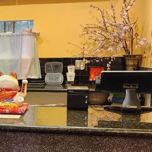 a counter with a computer and other items