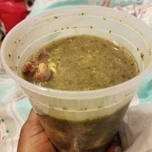 Callaloo chicken soup with bits of coconut in the dumpling