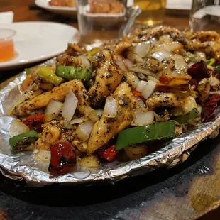 a platter of chicken and vegetables