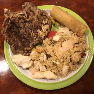 Fried pork hop with fried rice and egg roll,