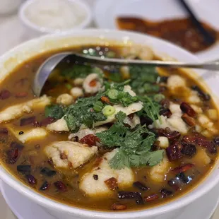 a bowl of soup with a spoon in it